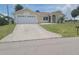 Charming single-story home featuring a two-car garage, well-kept lawn, and inviting curb appeal at 4611 Herman Cir, Port Charlotte, FL 33948