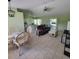 Spacious living room with tile floors, comfortable seating, and access to outdoor patio at 4611 Herman Cir, Port Charlotte, FL 33948