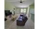 Comfortable living room with tile floors, a plush sofa, and plenty of natural light, perfect for relaxing at 4611 Herman Cir, Port Charlotte, FL 33948