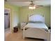 Cozy main bedroom features a white bed frame, a walk-in shower, and tile flooring at 4611 Herman Cir, Port Charlotte, FL 33948