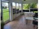 Enclosed sunroom featuring tile flooring, multiple windows with a view of the backyard at 4611 Herman Cir, Port Charlotte, FL 33948
