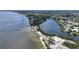 An aerial shot capturing the beauty of waterfront homes along a curving shoreline, with docks and boats dotting the water at 6948 W Country Club N Dr, Sarasota, FL 34243