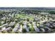 An aerial view of the neighborhood near a golf course and lake, highlighting the community's location at 6948 W Country Club N Dr, Sarasota, FL 34243