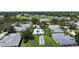 An aerial view showcasing the community pool and shuffleboard court in this beautiful neighborhood at 6948 W Country Club N Dr, Sarasota, FL 34243