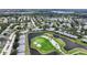 An aerial view capturing the community's layout near a golf course and lake with beautiful landscaping at 6948 W Country Club N Dr, Sarasota, FL 34243