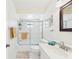 Bright bathroom featuring a shower with glass doors, a white vanity, and neutral decor at 6948 W Country Club N Dr, Sarasota, FL 34243