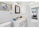 Cozy bathroom features a white vanity, framed art and an open doorway at 6948 W Country Club N Dr, Sarasota, FL 34243