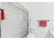 The full bath features a glass enclosed shower, white fixtures, and bright lighting at 6948 W Country Club N Dr, Sarasota, FL 34243