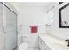 A full bathroom features white wainscoting, white fixtures and a glass enclosed shower with sliding doors at 6948 W Country Club N Dr, Sarasota, FL 34243