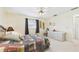 Neutral toned bedroom with ceiling fan, dresser and closet at 6948 W Country Club N Dr, Sarasota, FL 34243