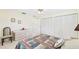 Neutral bedroom with a ceiling fan, a dresser and an oversized closet at 6948 W Country Club N Dr, Sarasota, FL 34243