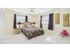 A neutral toned bedroom features a ceiling fan, two windows and a double closet at 6948 W Country Club N Dr, Sarasota, FL 34243