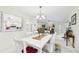 Charming dining room with white furnishings and a view into the kitchen, perfect for casual meals at 6948 W Country Club N Dr, Sarasota, FL 34243