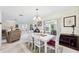 Bright dining area with a modern chandelier and sliding glass doors to the patio, perfect for entertaining at 6948 W Country Club N Dr, Sarasota, FL 34243