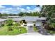Charming single-story home with lush landscaping, well-manicured lawn, and a two-car garage at 6948 W Country Club N Dr, Sarasota, FL 34243