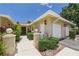 Well-maintained home exterior showcasing the attached two-car garage and neatly trimmed shrubs at 6948 W Country Club N Dr, Sarasota, FL 34243
