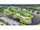 Scenic aerial view highlighting the golf course with a serene lake and residential community nearby at 6948 W Country Club N Dr, Sarasota, FL 34243