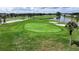 Enjoy a sunny day at the golf course, showcasing its beautifully manicured green and surrounding scenery at 6948 W Country Club N Dr, Sarasota, FL 34243