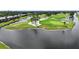 Aerial view of a picturesque golf course and surrounding community with stunning water features and green fairways at 6948 W Country Club N Dr, Sarasota, FL 34243