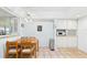 Bright eat-in kitchen featuring breakfast table, ceiling fan, and white cabinets at 6948 W Country Club N Dr, Sarasota, FL 34243