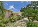 Attractive home exterior featuring lush landscaping and a well-manicured lawn at 6948 W Country Club N Dr, Sarasota, FL 34243