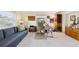 Cozy living room with a comfortable sofa, desk and chair, and natural light from the windows at 6948 W Country Club N Dr, Sarasota, FL 34243