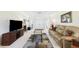 Inviting living room features neutral walls, plush carpeting, and a cozy seating area with natural light at 6948 W Country Club N Dr, Sarasota, FL 34243