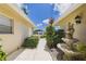 Inviting walkway leading to the home with a charming fountain and manicured landscaping at 6948 W Country Club N Dr, Sarasota, FL 34243