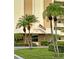 Lexington condominium entrance with American flag, palm trees, and well-manicured landscaping at 4750 Cove Cir # 502, St Petersburg, FL 33708