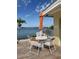 Patio seating area with views of the water, featuring an orange umbrella and table with four chairs at 4750 Cove Cir # 502, St Petersburg, FL 33708