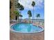 Inviting outdoor pool area with lounge seating, surrounded by well-maintained landscaping and clear blue skies at 4750 Cove Cir # 502, St Petersburg, FL 33708