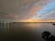 Beautiful sunset water view featuring boats, with hints of orange and pink in the sky at 4750 Cove Cir # 502, St Petersburg, FL 33708