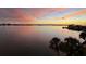 A stunning waterfront view with a colorful sunset sky casting reflections on the peaceful water at 4750 Cove Cir # 502, St Petersburg, FL 33708