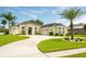 Charming single-story home with a beautiful lawn, circular driveway, and well-maintained landscaping at 14041 Bassingthorpe Dr, Spring Hill, FL 34609