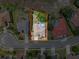 Aerial view of a home with a pool and lush landscaping surrounded by a well-maintained neighborhood at 1052 Archway Dr, Spring Hill, FL 34608