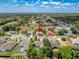 Aerial view showcases a charming neighborhood with a home featuring lush greenery at 1052 Archway Dr, Spring Hill, FL 34608