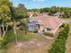 Aerial view of home with screened-in pool, landscaping, and backyard at 1052 Archway Dr, Spring Hill, FL 34608