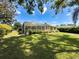 Large backyard with screened in pool enclosure at 1052 Archway Dr, Spring Hill, FL 34608