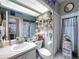 Unique bathroom with an artistic mirror, decorative accents, and ample storage space at 1052 Archway Dr, Spring Hill, FL 34608