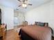 Spacious bedroom featuring wood floors and an en-suite bathroom for added privacy and convenience at 1052 Archway Dr, Spring Hill, FL 34608