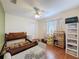 Comfortable bedroom with wood floors, a ceiling fan, and plenty of natural light for a restful retreat at 1052 Archway Dr, Spring Hill, FL 34608