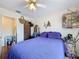 Cozy bedroom featuring a ceiling fan, wood floors, and comfortable furnishings at 1052 Archway Dr, Spring Hill, FL 34608