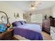 Cozy bedroom with ample natural light, a ceiling fan, and an accent decor collection at 1052 Archway Dr, Spring Hill, FL 34608