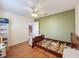 Neutral bedroom with wood laminate floors, ceiling fan, and neutral paint colors at 1052 Archway Dr, Spring Hill, FL 34608