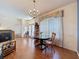Open dining room with hardwood floors, chandelier, and view to the front door at 1052 Archway Dr, Spring Hill, FL 34608