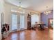 Inviting entryway featuring double glass doors, tile and wood floors, and stylish decor at 1052 Archway Dr, Spring Hill, FL 34608