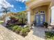 Welcoming front entrance with a blue double door, a paver walkway, and attractive landscaping at 1052 Archway Dr, Spring Hill, FL 34608