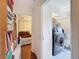 Hallway with tile flooring leading to a laundry room and bedroom with natural light at 1052 Archway Dr, Spring Hill, FL 34608