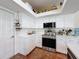 Kitchen with stainless steel appliances and white cabinets at 1052 Archway Dr, Spring Hill, FL 34608