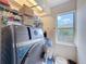 Bright laundry room featuring a modern washer and dryer, shelving, and a window at 1052 Archway Dr, Spring Hill, FL 34608
